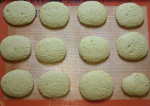 Photo of twelve freshly baked matcha green tea cookies.