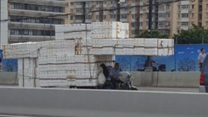 Moped covered in Styrofoam boxes.